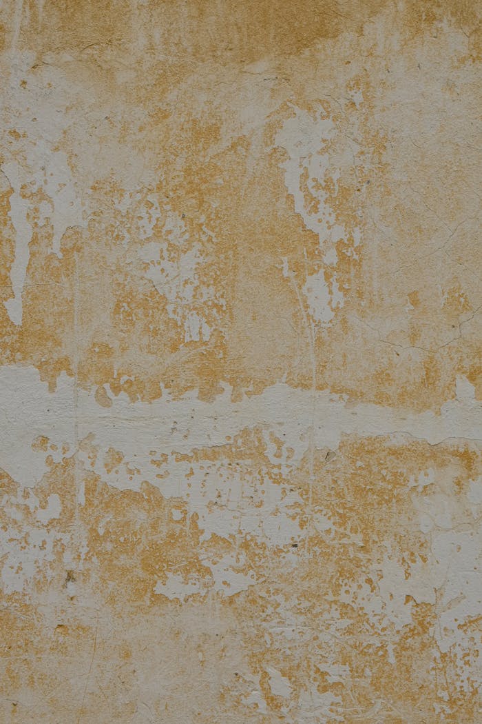 Close-up of a weathered concrete wall with yellow stains in Estonia.